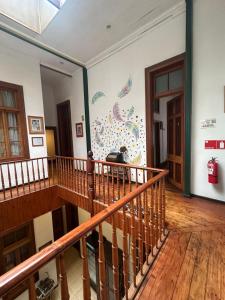 a person sitting on the stairs of a building at Da Vinci in Valparaíso
