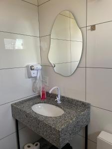 a bathroom with a sink and a mirror at AL&V Hotel in Santa Tereza do Oeste +11 photos