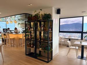 a room with a shelf with plants and a bar at Poblado de lujo in Medellín