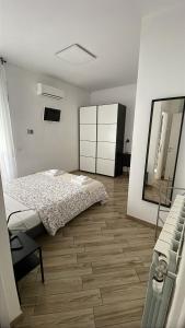 a bedroom with a bed and a dresser and a mirror at Dolce Vita Affittacamere in Rome