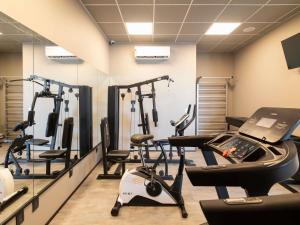 a gym with several treadmills and exercise bikes at ibis Tubarão in Tubarão +131 photos