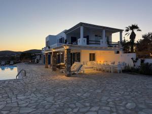 a house with a patio and a swimming pool at The Aegean Horizon Villa in Grótta