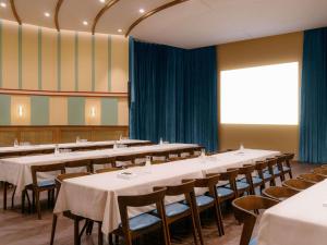 a row of tables and chairs in a room at The Hoxton Vienna in Vienna +105 photos