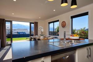 a kitchen with a sink and a counter top at Spacious, Family-Friendly, Parkside - KK67479 in Kaikoura +15 photos