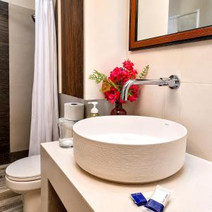 a bathroom with a sink and a toilet at COCOVIEW Hotel in Valle de Ángeles +30 photos