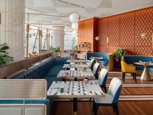 a row of tables in a restaurant at Swissôtel Corniche Park Towers Doha in Doha