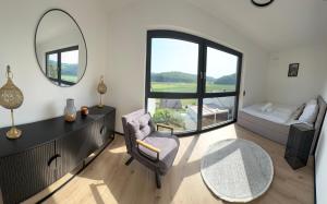 a living room with a table and a mirror at Design-Villa mit privatem Whirlpool&Naturblick in Wellheim