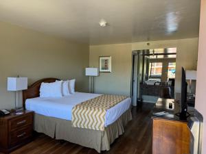a hotel room with a bed and a television at Travelodge by Wyndham Reno in Reno