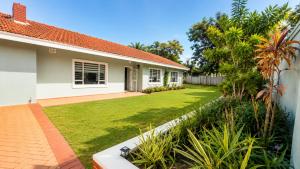 a house with a lawn in front of it at Umhlanga La Lucia Oasis, Family Friendly Accommodation in Durban