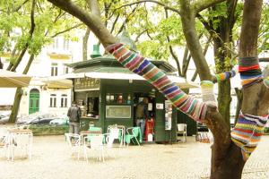 a tree with knitted bracelets on it in front of a store at Charming Apartment Tram 28 in Lisbon
