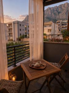 a table and chair on a balcony with a view at Johanan 2 in Makarska