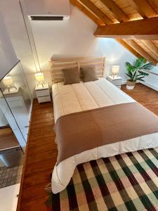 a bedroom with a large bed with two night stands at Casas Morgado in Valada +64 photos