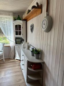 a kitchen with a counter and a clock on the wall at My little happy place in Undva