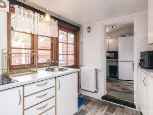 a kitchen with a sink and a refrigerator at 4 person holiday home in Ærøskøbing-By Traum in Ærøskøbing +57 photos