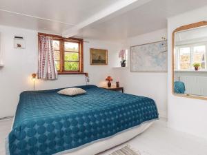 a bedroom with a large blue bed in a room at 4 person holiday home in Ærøskøbing-By Traum in Ærøskøbing