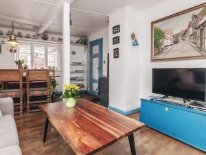 a living room with a tv and a wooden table at 4 person holiday home in Ærøskøbing-By Traum in Ærøskøbing