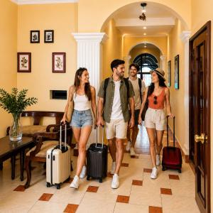a group of people walking down a hallway with luggage at Hotel Mediterraneo Quito in Quito