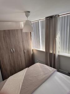 a bedroom with a bed and a window at Smile home 2, Zaanse schans and Amsterdam Appartements in Wormerveer