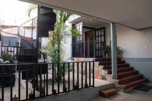 a house with a staircase leading to the front door at Casa Origen in Oaxaca City