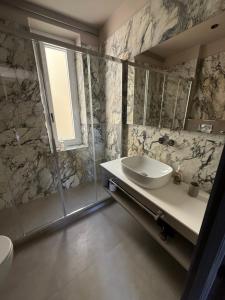 a bathroom with a sink and a shower at CAST AWAY in Riomaggiore
