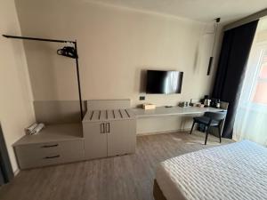 a hotel room with a bed and a desk and a chair at CAST AWAY in Riomaggiore