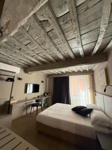 a bedroom with a large bed and a desk at CAST AWAY in Riomaggiore