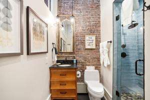 a bathroom with a toilet and a glass shower at The Luxe Loft Knoxville in Knoxville +30 photos