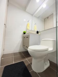 a bathroom with a white toilet and a sink at Apartamento Paradise in Ibagué