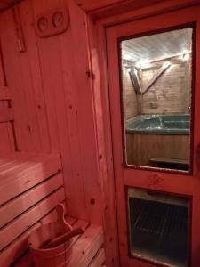 a red room with a window and a tub at TOŁHAJÓWKA in Strzebowiska +17 photos