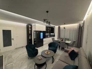 a living room with a couch and chairs and a table at Apartment Lumos in Ljubuški +8 photos