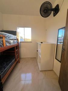 a room with two bunk beds and a refrigerator at Wind Life Home in Itarema