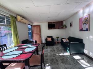 a living room with a table and a couch at Tropical Haus CR - El Manglar in Puerto Jiménez