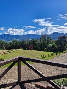 a view of the mountains from the porch of a house at Cabana Zermatt in Timbe do Sul