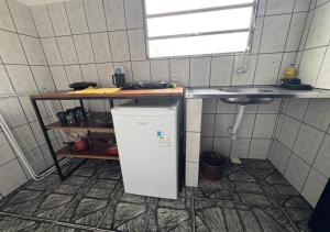 a small kitchen with a sink and a refrigerator at Margarida AP 3 in Presidente Figueiredo +6 photos