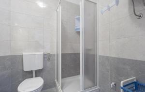 a bathroom with a toilet and a shower at Apartments by the sea Metajna, Pag - 6289 in Zubovići
