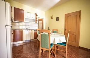 a kitchen with a table and chairs and a refrigerator at Apartments by the sea Metajna, Pag - 6289 in Zubovići