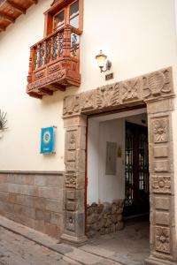 an entrance to a building with a balcony and a door at Illa Hotel in Cusco