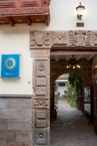 an entrance to a building with a sign on it at Illa Hotel in Cusco