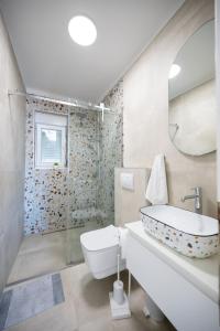 a bathroom with a tub and a toilet and a sink at Apartments by the sea Stara Novalja, Pag - 6301 in Stara Novalja