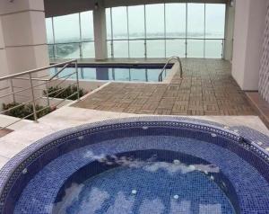 a large swimming pool in the middle of a building at lighthouse view piso 8 in Guayaquil +1 photo
