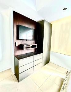 a living room with a tv on a wall at lighthouse view piso 8 in Guayaquil