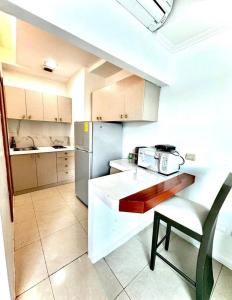 a kitchen with a refrigerator and a chair in it at lighthouse view piso 8 in Guayaquil