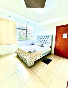 a bedroom with a bed and a large window at lighthouse view piso 8 in Guayaquil