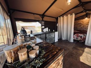 a kitchen with a table in a tent at Orpheus Camping in Kaneb Pos
