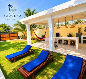 a patio with two lounge chairs and a gazebo at Villa Azucena Monterrico in Monterrico