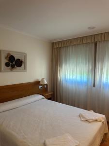 a bedroom with a large bed and a window at Hermida Rural in Eirejalba