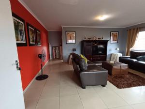 a living room with a couch and a fireplace at Toekies and Abel in Cape Town