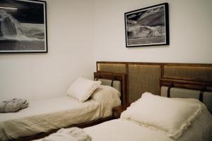 a room with two beds and two pictures on the wall at DePhazz I Wellness Clinic & Spa in Junín