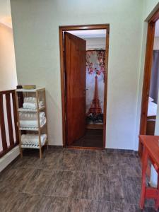 a room with a door and a view of the eiffel tower at Lihuen in Mar Azul +7 photos