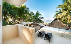 a view of the beach from the balcony of a resort at Cocuna Boutique Suites La Manzanilla Jalisco in La Manzanilla